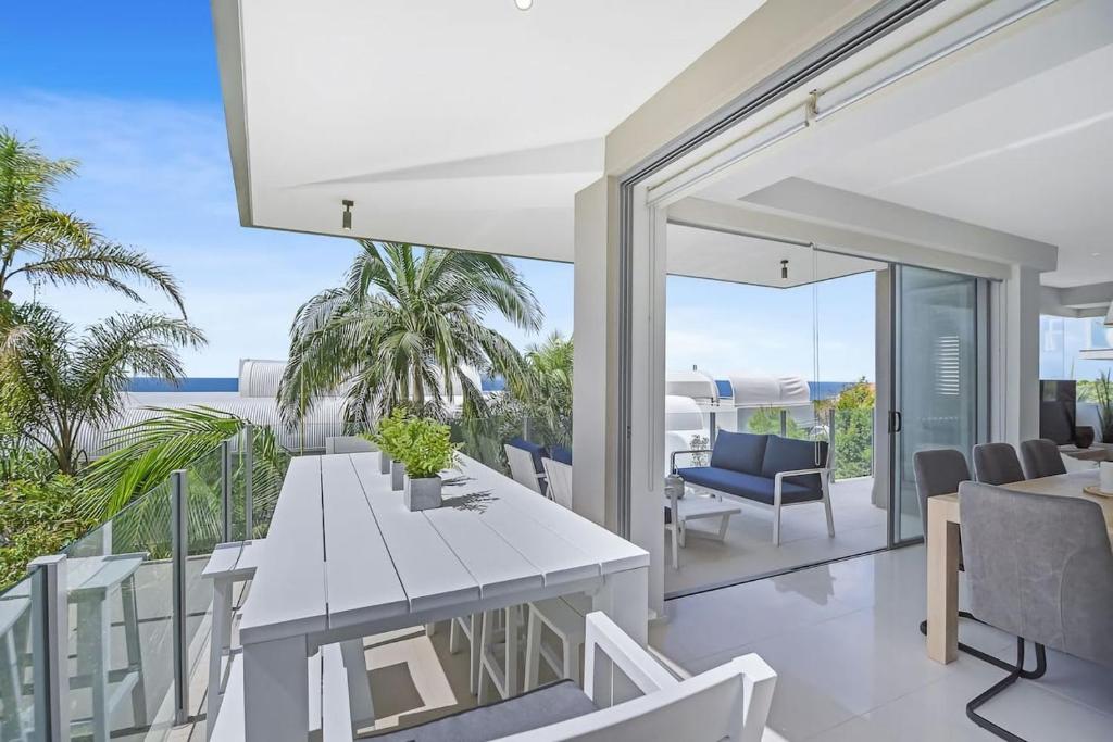 a dining room with a view of the ocean at Coastal Chic with Heated Pool Quiet Location in Sunshine Beach