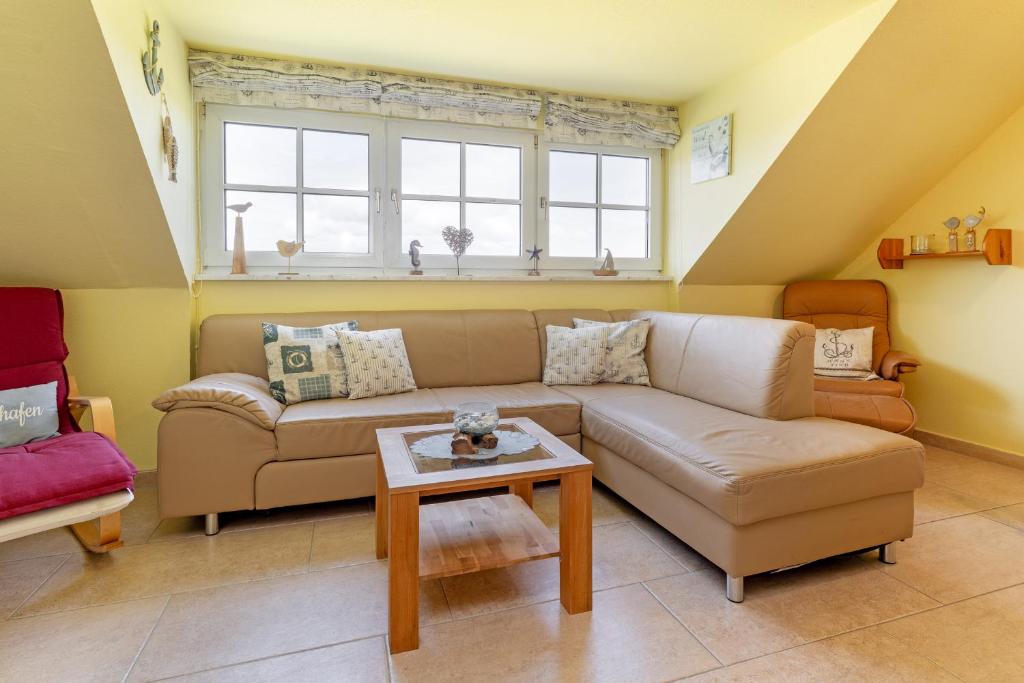 a living room with a couch and a table at Seehaus in Bojendorf