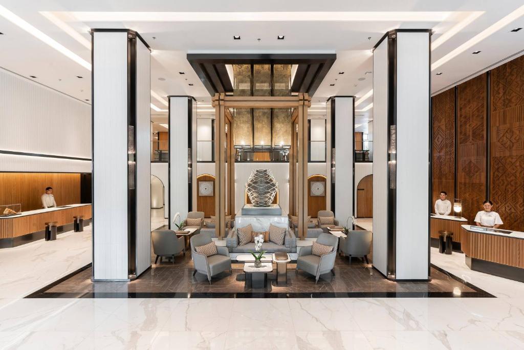 a lobby of a hotel with chairs and a waiting room at Meliá Chiang Mai in Chiang Mai