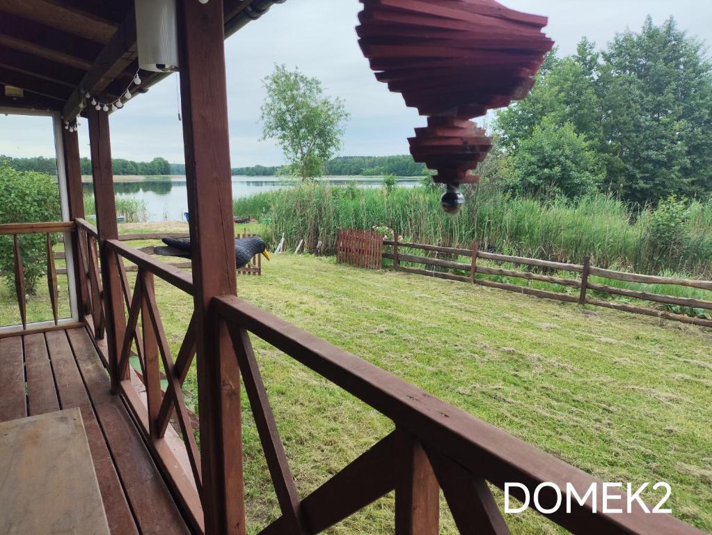 a view from the porch of a house with a fence at Gospodarstwo Agroturystyczne RYBAKÓWKA in Warlubie
