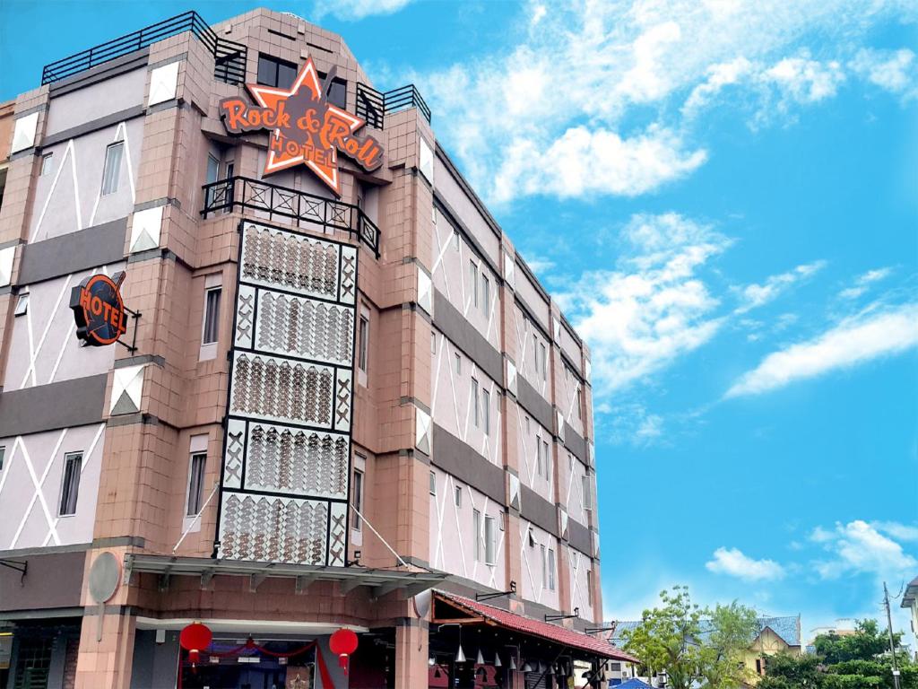 a building with a star sign on the side of it at Rock & Roll Hotel Klang in Klang