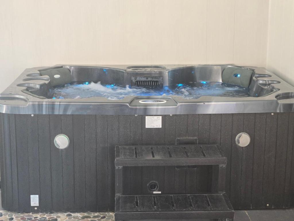 a jacuzzi tub in the corner of a room at L'Argonnière in Buzancy