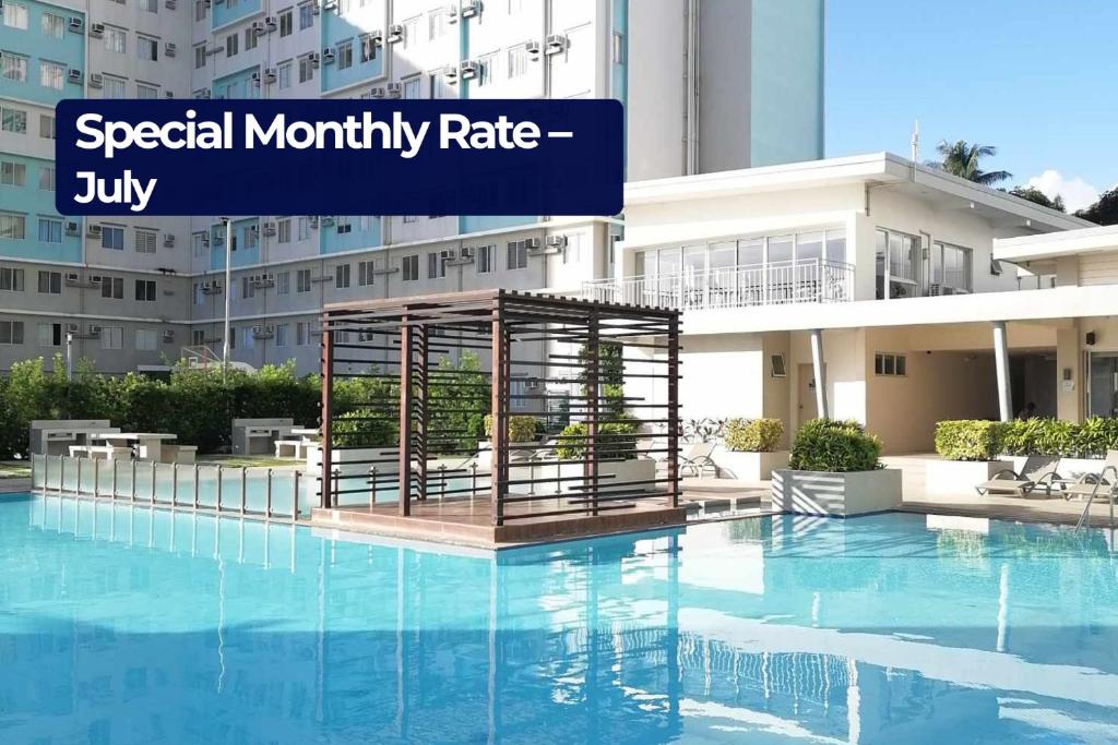 a large swimming pool with a cage in front of a building at Mountain View Studio at Marina Spatial - 300Mbps, Pool, City Centre in Dumaguete