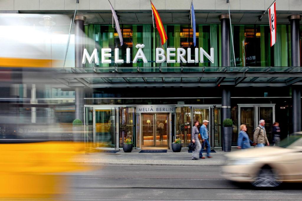 a bus driving in front of a building at Meliá Berlin in Berlin