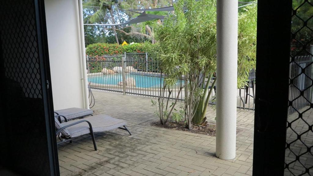 an open door to a patio with a swimming pool at Sol Y Olas Sun and Waves in Arcadia