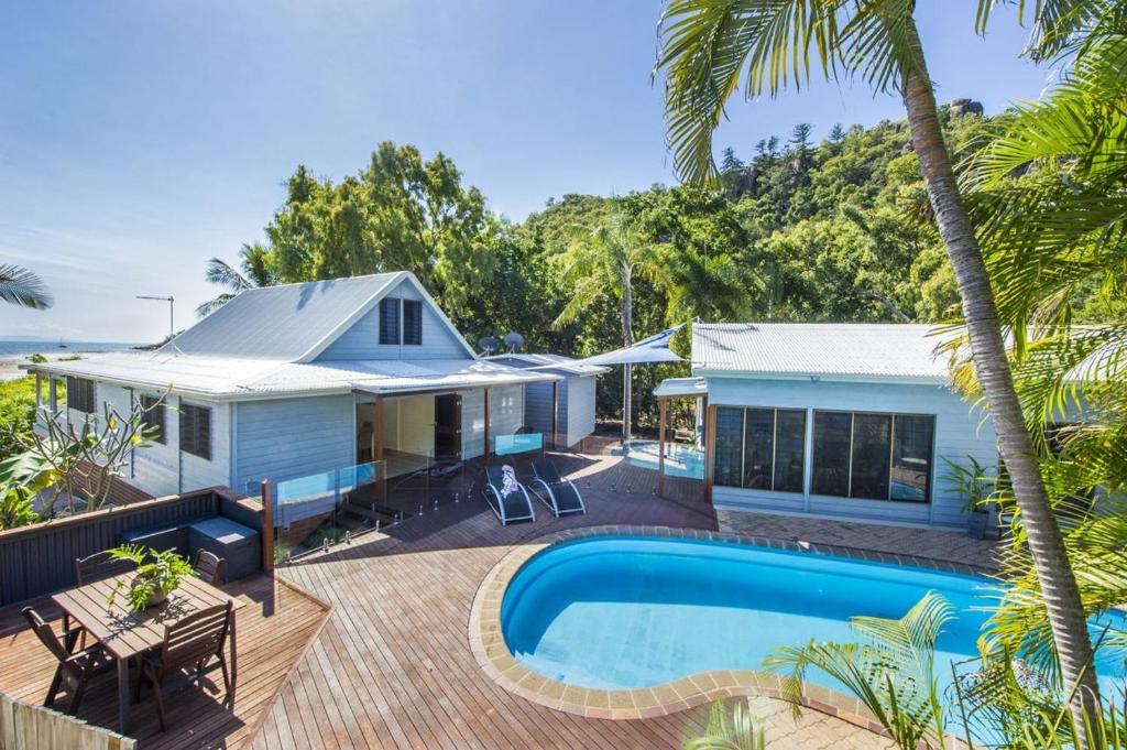 a house with a swimming pool and a deck at On the Beach in Horseshoe Bay