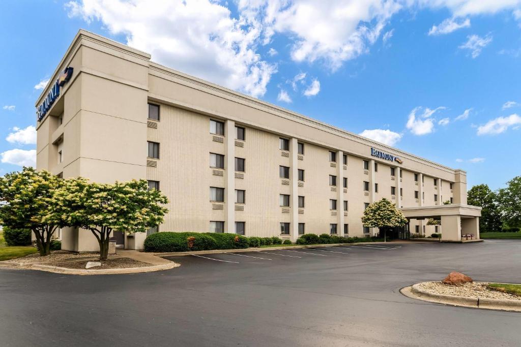 an exterior view of a hotel with a parking lot at Baymont by Wyndham Janesville in Janesville