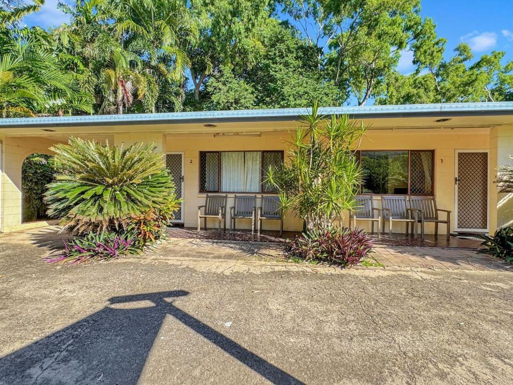 a building with chairs and plants in front of it at Arcadia Palms 2 in Arcadia