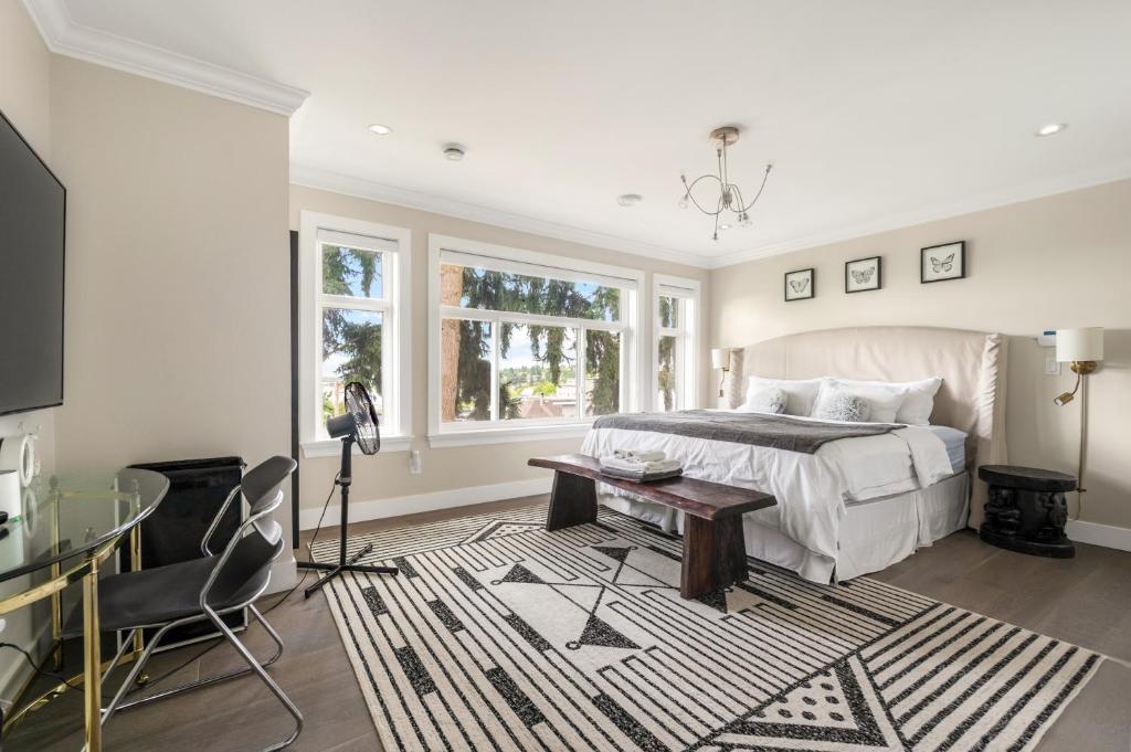a bedroom with a bed and a table and a desk at 5-Star Luxury and comfortable home in New Westminster