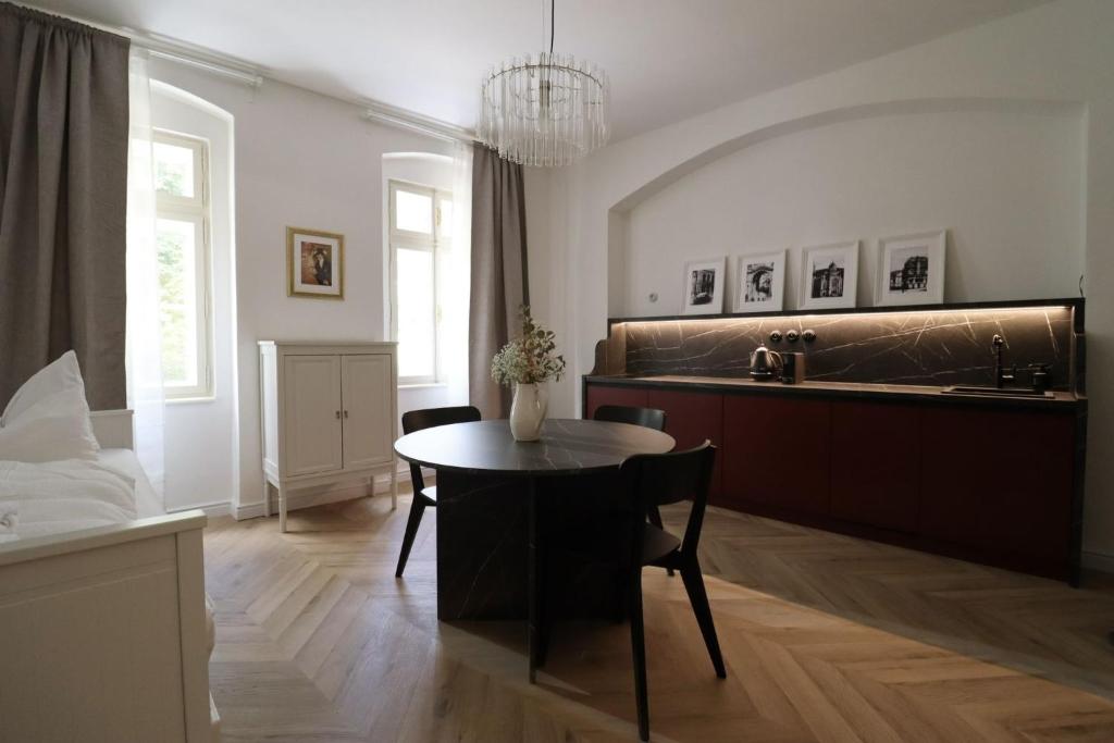 a living room with a table and a kitchen at Monte-Rosa in Karlovy Vary