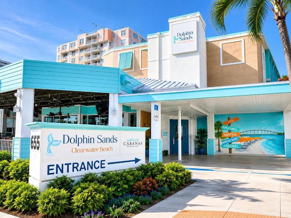 a building with a sign in front of it at Dolphin Sands Clearwater Beach, an Ascend Collection Hotel in Clearwater Beach