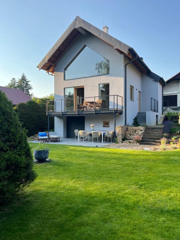a house with a large lawn in front of it at chata Jarka in Jivno