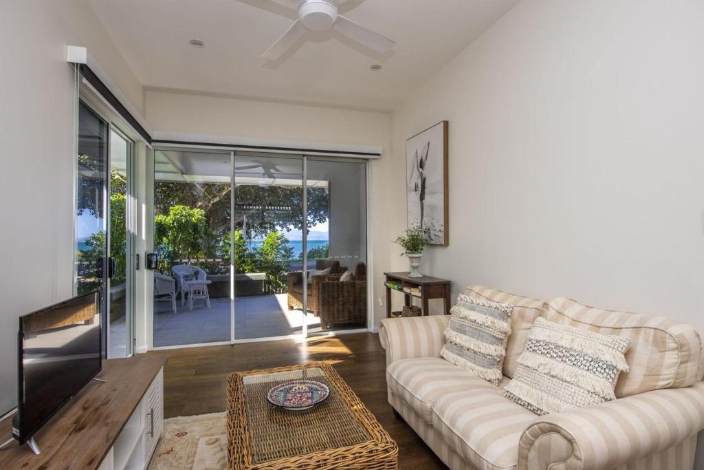 a living room with a couch and a tv at Reflections Topaz Villa 3 in Picnic Bay