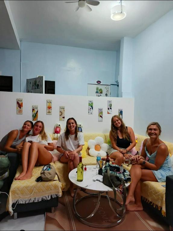 a group of women sitting on a couch at Mahika Guest House Siquijor in San Juan