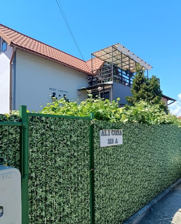 a sign on a fence in front of a house at Casa OZZY&PATTY in 2 Mai