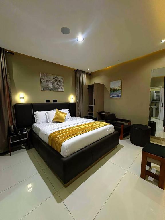 a bedroom with a large bed in a room at Ciamo Hotel in Ikeja