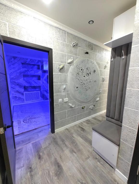 a room with a large shower with a glass door at Apartments in Taraz