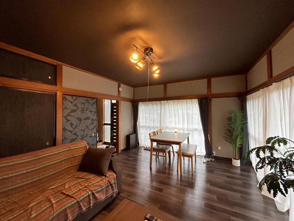 a living room with a couch and a table at Kawazu Sakura-so in Kawazu
