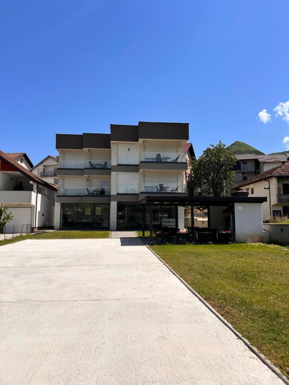 a large building with a walkway in front of it at Apartmani SEEBLICK in Konjic