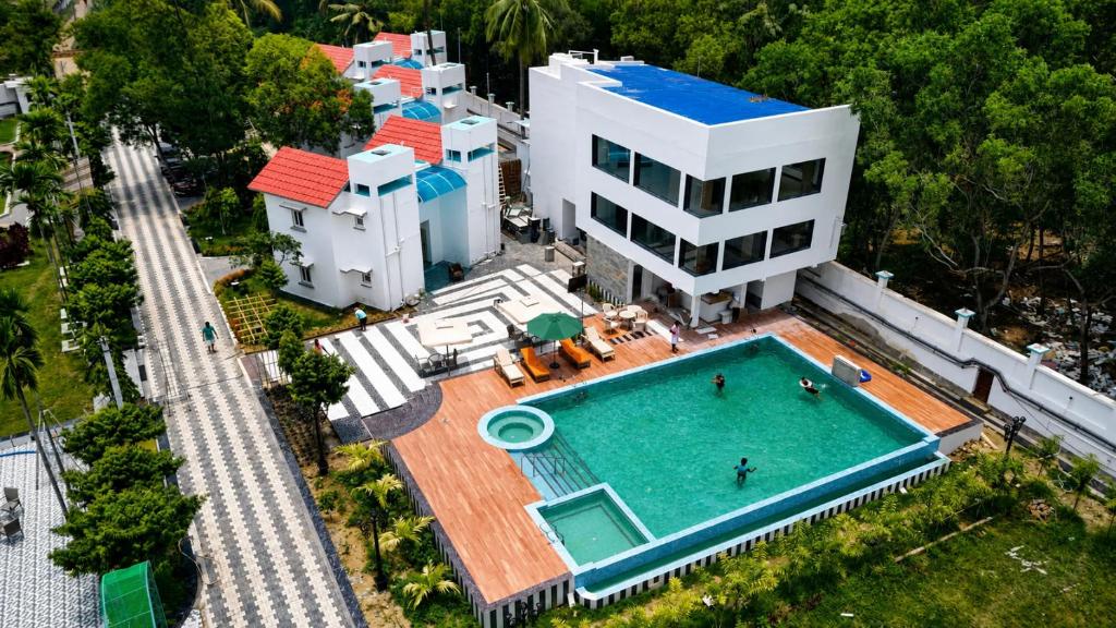 an aerial view of a house with a swimming pool at Jowar Hotel & Resort in Digha