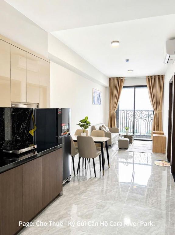 a living room with a kitchen and a dining room at Cara River Park in Cái Răng