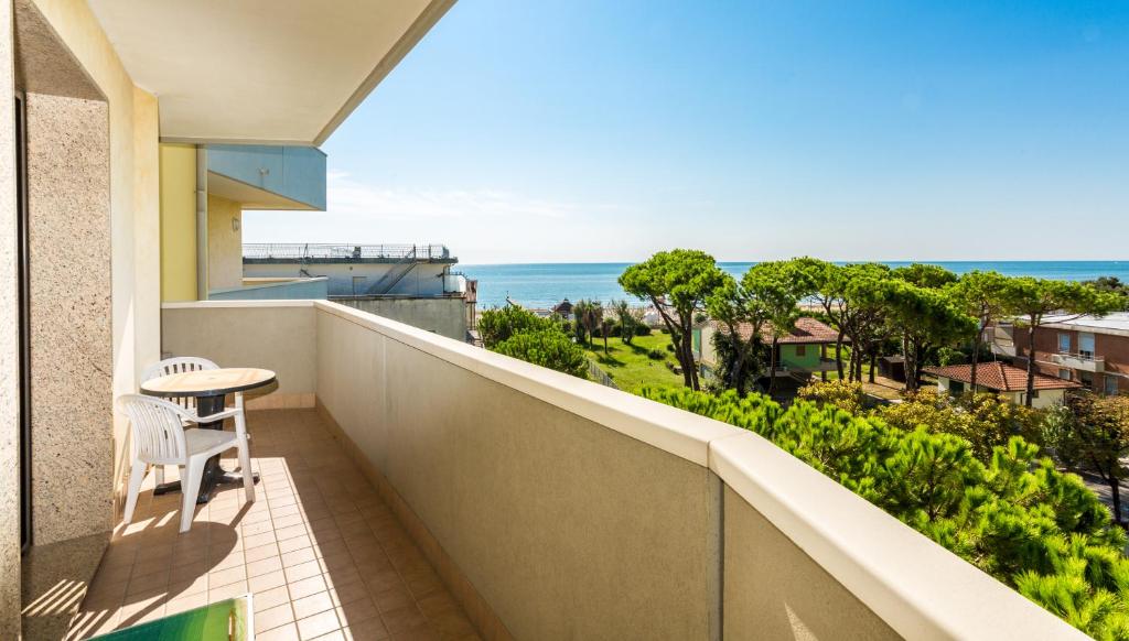 a balcony with a table and a view of the ocean at Residence California in Lido di Jesolo