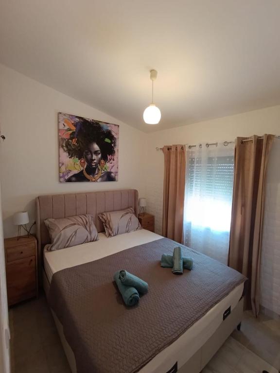 a bedroom with a bed with two towels on it at Apartman Mivela in Vir