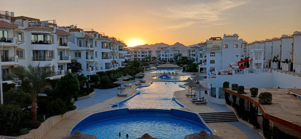 a view of a resort with a pool and buildings at Red Sea Serenity in Sharm El Sheikh