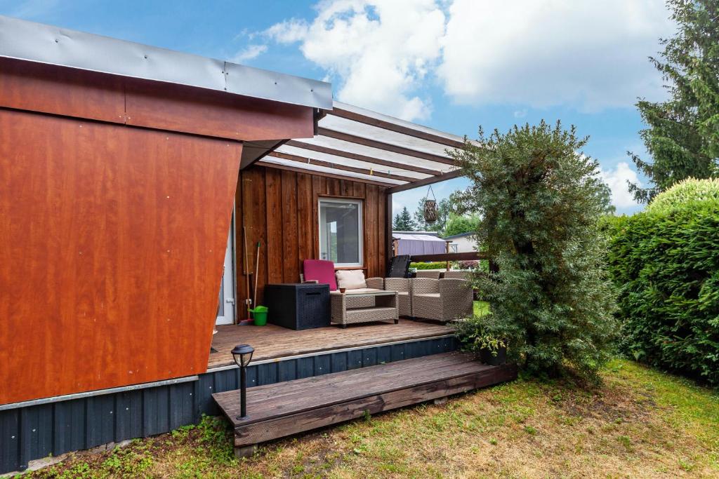 a backyard deck with a patio furniture and a building at Ferienhaus 36 in Zadelsdorf