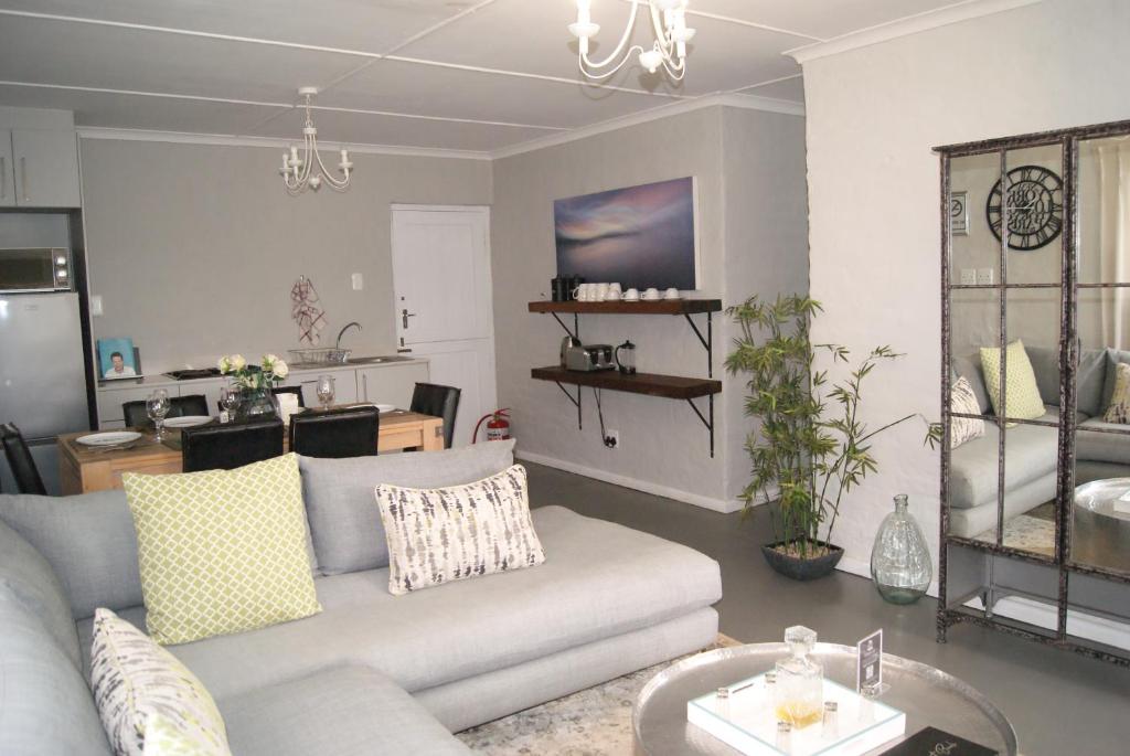 a living room with a couch and a table at Chalet Kudu in Ladismith