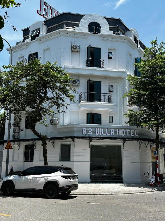 a white car parked in front of a building at A3 Villa Hotel - Gia Lâm in Thạch Cầu