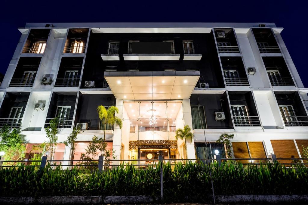 a large white building with a lit up doorway at Luxe By Lotels in Chennai