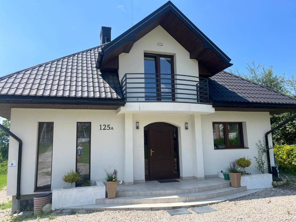a white house with a black roof at Villa Anna in Nowy Targ
