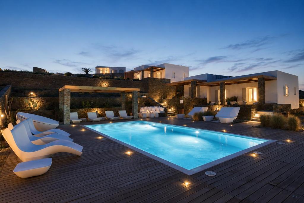 a villa with a swimming pool at night at Elements Sifnos in Sifnos