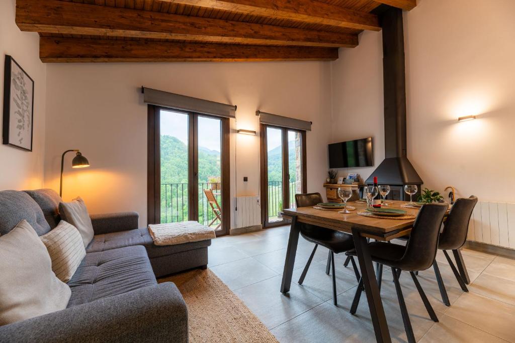 a living room with a couch and a table at Can Pont in Camprodon