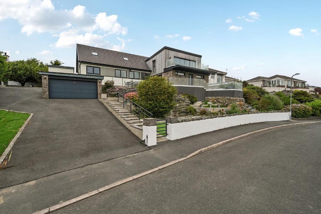 a large house with a garage and a driveway at Seaddler in Holyhead