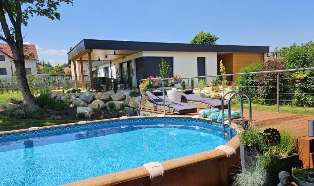 a swimming pool in a yard next to a house at Chalet Maier in Landschach