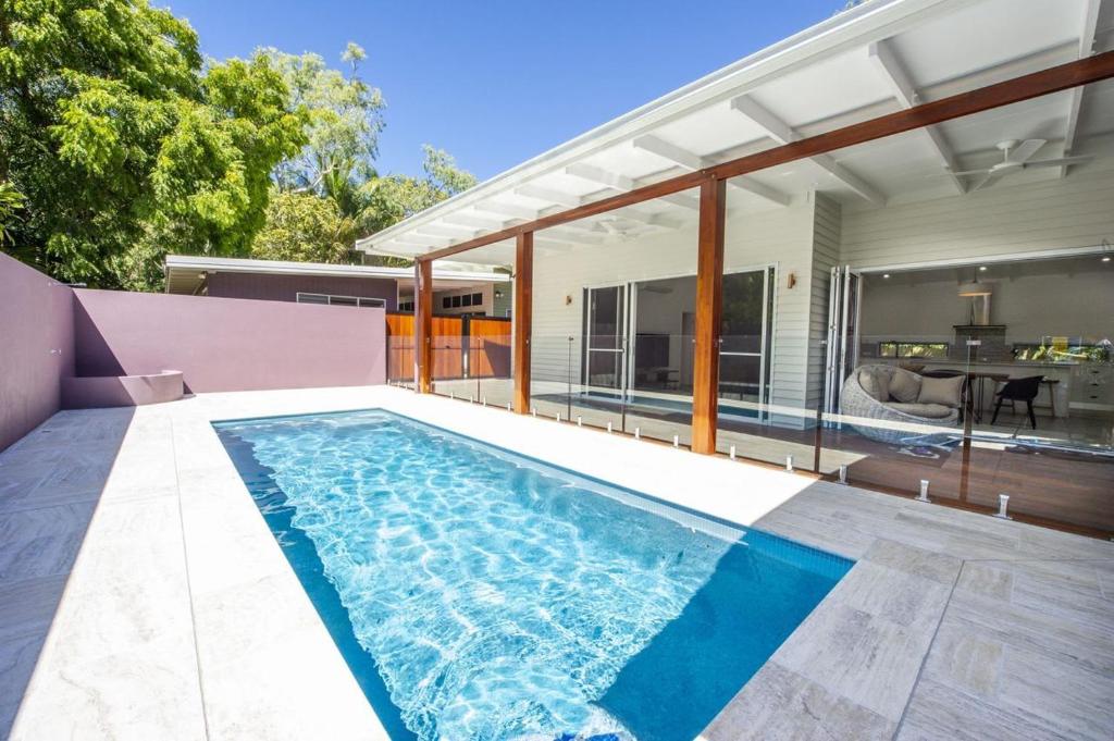 a swimming pool in the backyard of a house at Papillon Bleu in Horseshoe Bay