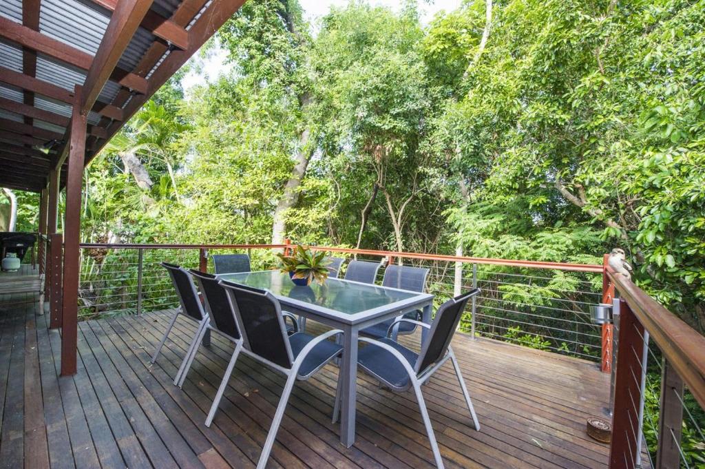 a patio with a table and chairs on a deck at Magnetic Effect in Arcadia