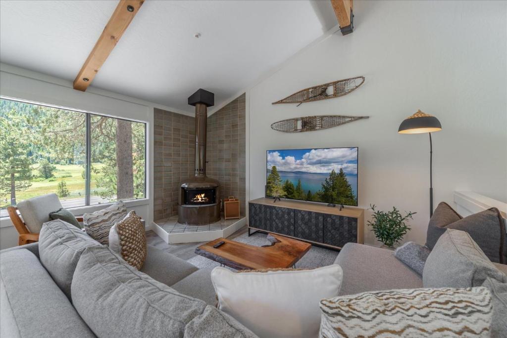 a living room with a couch and a fireplace at Alpenglow Loft condo in Olympic Valley