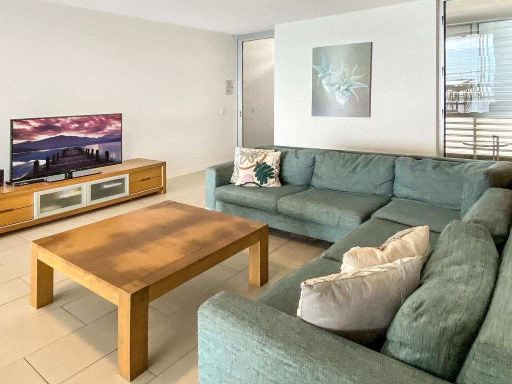 a living room with a couch and a coffee table at 1 Bright Point Apartment 4502 in Nelly Bay