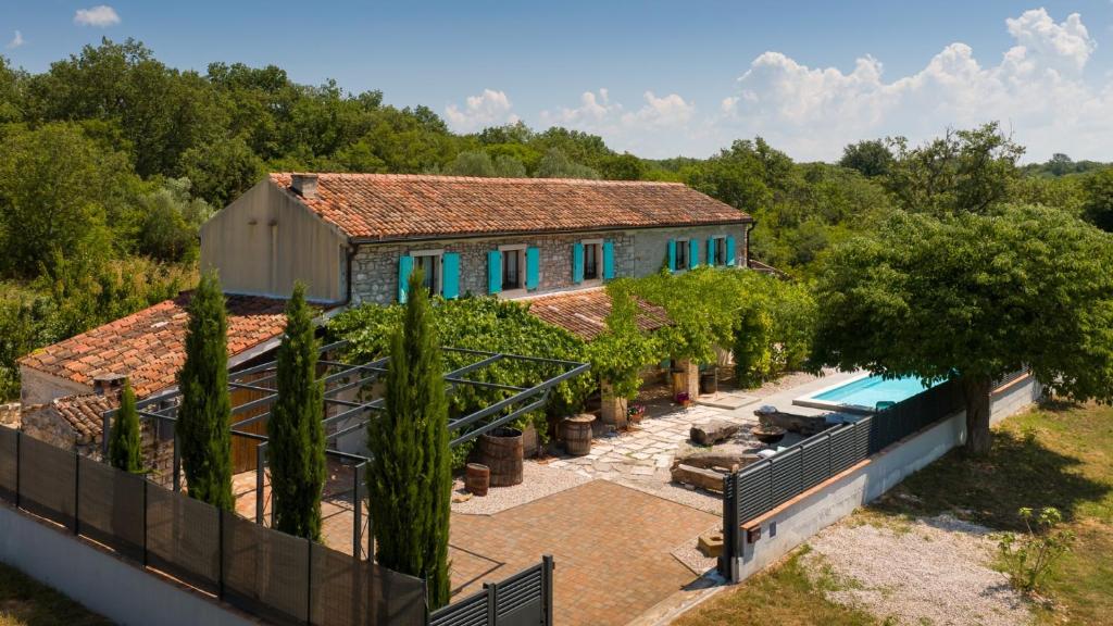 an aerial view of a house with a pool and trees at Old House Grota by Villas Guide in Umag