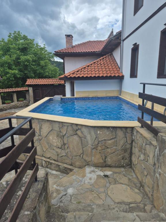 a swimming pool in front of a house at Къща Цачеви 2 in Tryavna