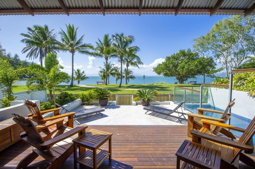 a deck with chairs and a view of the ocean at Beached on Magnetic in Picnic Bay