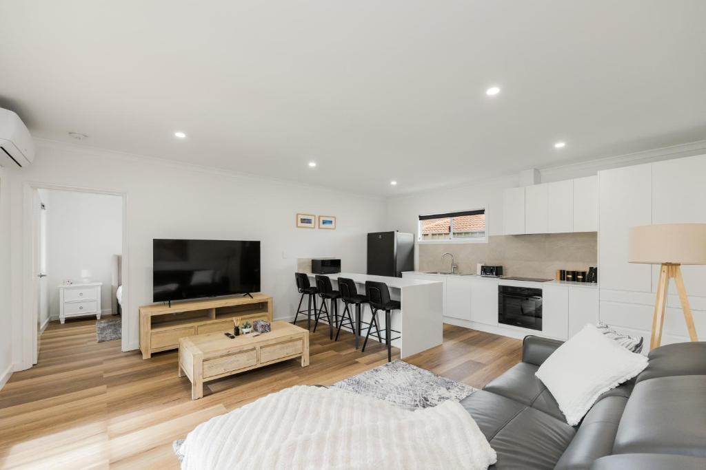 a living room with a couch and a table at Ralph Escapes Kingsley in Perth