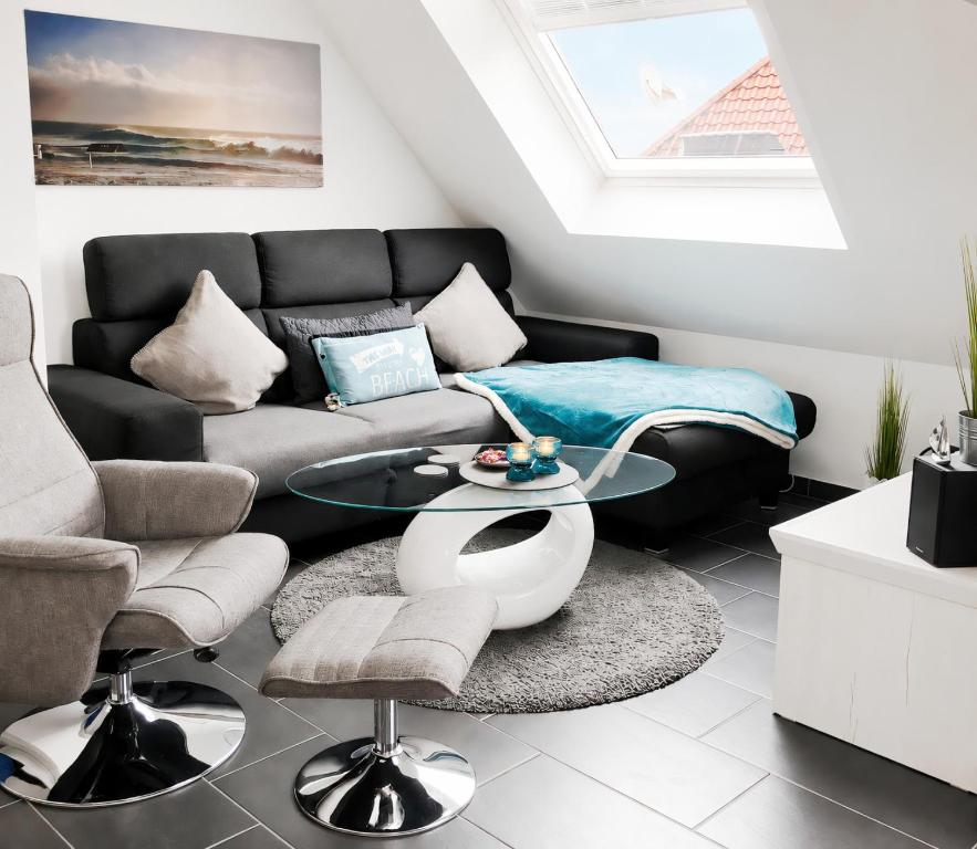 a living room with a couch and a table at Sonnendeck 36 - Großenbrode in Grossenbrode