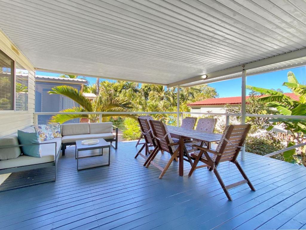 a patio with a table and chairs on a deck at Magnetic Haven Unit 5 in Arcadia