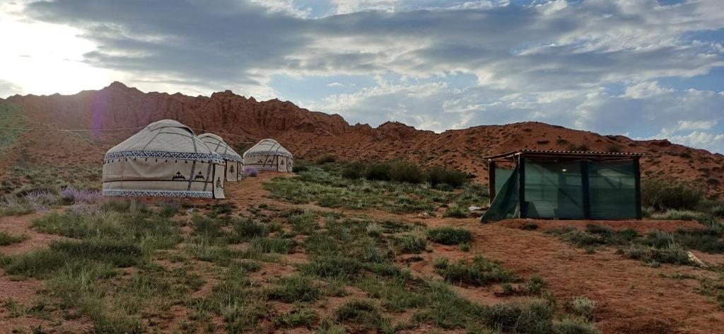 two domes in the desert with mountains in the background at Kyzyl-Jar in Kaji-Say