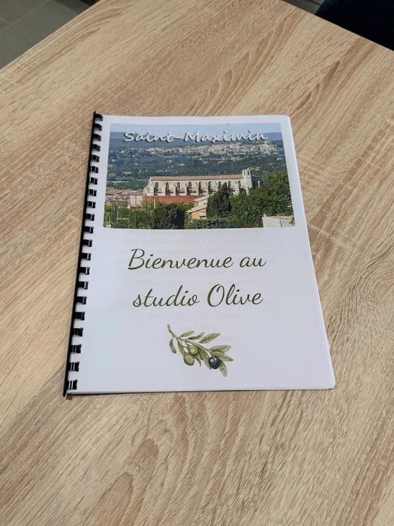 a book on a table with a picture of a building at Les studios du Général - Lavande in Saint-Maximin-la-Sainte-Baume