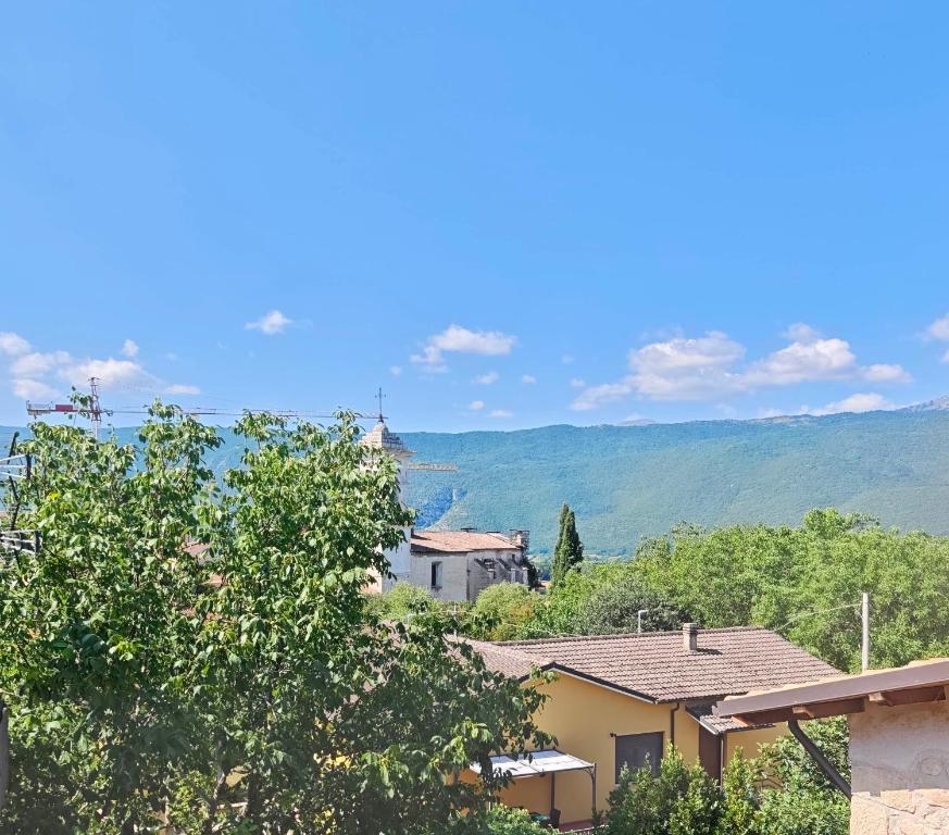 a view of a house with mountains in the background at Dimora Visconti in San Demetrio neʼ Vestini